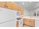 Kitchen features white appliances, wooden cabinets and tiled floors at 821 Laquinta Loop, Murrells Inlet, SC 29576