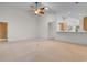 Bright living room featuring a ceiling fan and an opening into the kitchen at 821 Laquinta Loop, Murrells Inlet, SC 29576