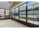 Spacious screened porch with ample sunlight and views of the green backyard, creating a relaxed atmosphere at 821 Laquinta Loop, Murrells Inlet, SC 29576