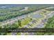Expansive aerial view of homes with sidewalks that surround a retention pond and green spaces at 832 Windsor Rose Dr., Conway, SC 29526