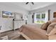 Bright bedroom features a ceiling fan, tray ceiling, wood-look floors, and a view of the yard at 832 Windsor Rose Dr., Conway, SC 29526