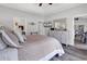 This bedroom features wood-look floors, tray ceiling, TV, and doorway to an adjoining room at 832 Windsor Rose Dr., Conway, SC 29526