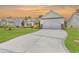 Long driveway leading to a two-car garage and a well-maintained lawn at 832 Windsor Rose Dr., Conway, SC 29526