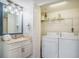 Well lit bathroom next to a closet featuring a stacked washer and dryer at 8560 Queensway Blvd. # 106, Myrtle Beach, SC 29572