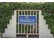 Entrance sign for The Brighton at Kingston Plantation featuring decorative fence and lush foliage at 8560 Queensway Blvd. # 106, Myrtle Beach, SC 29572
