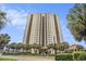 High rise condo building exterior showing the entrance and lush landscaping at 8560 Queensway Blvd. # 106, Myrtle Beach, SC 29572