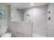Modern walk-in shower with marble tile surround at 8560 Queensway Blvd. # 106, Myrtle Beach, SC 29572