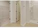 Bright bathroom featuring tiled floors, a shower and a closet, creating a functional space at 863 Long Beach Dr, Longs, SC 29568