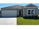 Charming single-story home with a gray exterior, attached garage, and well-maintained lawn at 863 Long Beach Dr, Longs, SC 29568