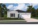 Inviting single-story home with light blue siding, a dark roof, and a well-manicured front yard at 863 Long Beach Dr, Longs, SC 29568