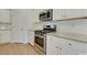 Updated kitchen with white cabinetry, stainless steel appliances including range and microwave, and subway tile backsplash at 863 Long Beach Dr, Longs, SC 29568