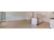 Spacious living area with hardwood floors, white walls, and a modern kitchen area at 863 Long Beach Dr, Longs, SC 29568