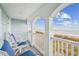 Relax on the covered balcony with ocean views and comfortable seating, perfect for enjoying the coastal breeze at 931 S Ocean Blvd., North Myrtle Beach, SC 29582