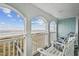 Relax on the covered balcony with ocean views and comfortable seating, perfect for enjoying the coastal breeze at 931 S Ocean Blvd., North Myrtle Beach, SC 29582