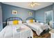 Bright bedroom featuring two beds, hardwood floors, fresh linens, and natural light from the doorway at 931 S Ocean Blvd., North Myrtle Beach, SC 29582