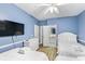 Bright blue bedroom features three beds and has an ensuite bathroom at 931 S Ocean Blvd., North Myrtle Beach, SC 29582