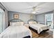 Comfortable bedroom featuring two beds, ceiling fan and adjoining bath at 931 S Ocean Blvd., North Myrtle Beach, SC 29582