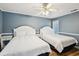 Cozy bedroom with two beds, ceiling fan, and side tables at 931 S Ocean Blvd., North Myrtle Beach, SC 29582