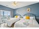 Bright bedroom featuring two beds, hardwood floors, fresh linens, and sliding door access to the balcony at 931 S Ocean Blvd., North Myrtle Beach, SC 29582