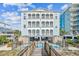 Stunning beachfront home with multiple balconies overlooking a refreshing pool and featuring a private walkway at 931 S Ocean Blvd., North Myrtle Beach, SC 29582