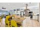 Bright open kitchen with granite countertops, stainless steel appliances, and vibrant yellow bar stools at 931 S Ocean Blvd., North Myrtle Beach, SC 29582