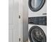 Modern, stacked washer and dryer set in a bright laundry area at 931 S Ocean Blvd., North Myrtle Beach, SC 29582