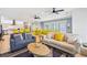 Open-concept living space with comfortable seating, ceiling fans, and a glimpse into the kitchen at 931 S Ocean Blvd., North Myrtle Beach, SC 29582