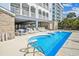 Community pool and grilling area surrounded by lounge chairs and tables provides a welcoming area to guests at 931 S Ocean Blvd., North Myrtle Beach, SC 29582