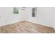Clean bedroom filled with light from two windows, complemented by wood-look flooring and a modern A/C unit at 1004 Georgetown St., Marion, SC 29571