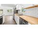 Bright kitchen with stainless steel appliances, butcher block countertops and white cabinetry at 1004 Georgetown St., Marion, SC 29571