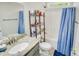 Bright bathroom with a single sink vanity, a tub-shower combo, and natural light at 1013 Happy Ln., Galivants Ferry, SC 29544