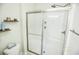 Clean bathroom with a sliding glass door shower, neutral walls, and tiled floor. Airy and easy to maintain at 1013 Happy Ln., Galivants Ferry, SC 29544