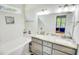 Well-lit bathroom featuring a double sink vanity with granite countertops and a tub with shower at 1013 Happy Ln., Galivants Ferry, SC 29544