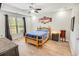 Bright bedroom with natural light, features a wooden bed frame, neutral walls, and a ceiling fan for added comfort at 1013 Happy Ln., Galivants Ferry, SC 29544