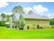 A charming single-story home with light green siding, a gray metal roof, and lush green lawn at 1013 Happy Ln., Galivants Ferry, SC 29544