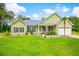 Charming single-story home with a lush green lawn, tidy landscaping, and a welcoming front porch at 1013 Happy Ln., Galivants Ferry, SC 29544