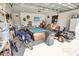 Organized garage featuring various equipment such as a pool table, motorcycles, and lawn mower at 1013 Happy Ln., Galivants Ferry, SC 29544