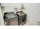 Modern laundry room with stainless steel washer and dryer, wire rack shelving, and decor at 1013 Happy Ln., Galivants Ferry, SC 29544