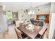 Open-concept living space blending the dining and living area with vaulted ceilings and hardwood floors at 1013 Happy Ln., Galivants Ferry, SC 29544