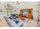 Cozy living room with vaulted ceiling, hardwood floors, comfortable seating, and a wooden entertainment center at 1013 Happy Ln., Galivants Ferry, SC 29544