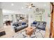 Open concept living room with hardwood floors, comfortable seating, and views of the kitchen and dining areas at 1013 Happy Ln., Galivants Ferry, SC 29544