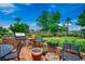 Outdoor kitchen area with a built-in grill, seating, and lush landscaping at 1017 Coral Reef Dr., North Myrtle Beach, SC 29582