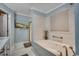 Spa-like bathroom featuring a soaking tub, marble countertops, and modern fixtures at 1017 Coral Reef Dr., North Myrtle Beach, SC 29582