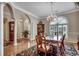 Formal dining room with hardwood floors, classic columns, and elegant chandelier at 1017 Coral Reef Dr., North Myrtle Beach, SC 29582