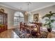 Bright dining room featuring hardwood floors, a chandelier, and large window at 1017 Coral Reef Dr., North Myrtle Beach, SC 29582