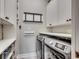 Well-organized laundry room with ample storage space and modern washer and dryer at 1017 Coral Reef Dr., North Myrtle Beach, SC 29582