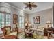 Cozy living room with wicker furniture, a ceiling fan, and beautiful window shutters at 1017 Coral Reef Dr., North Myrtle Beach, SC 29582
