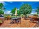 Expansive brick patio with multiple seating areas, a large dining table, and a built-in grill, perfect for outdoor gatherings at 1017 Coral Reef Dr., North Myrtle Beach, SC 29582
