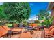 Inviting brick patio with comfortable seating, lush landscaping, and a cozy fire pit, perfect for outdoor relaxation and entertaining at 1017 Coral Reef Dr., North Myrtle Beach, SC 29582