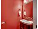 Stylish powder room with a decorative mirror, modern fixtures, and a vibrant wall color at 1017 Coral Reef Dr., North Myrtle Beach, SC 29582